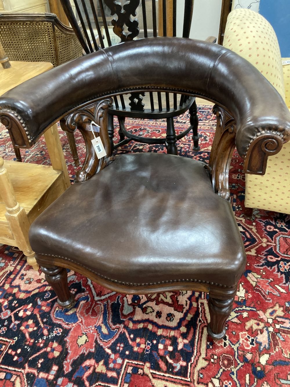A Victorian mahogany and brown leather library chair
